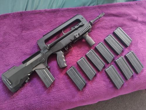 More information about "Tokyo Marui FAMAS F1, Upgraded, Real Steel full length Top Rail and 10 Mags."